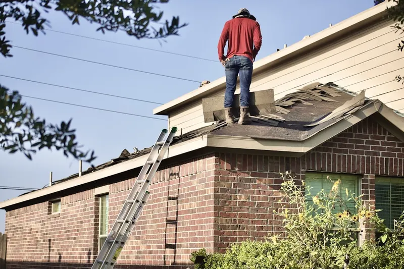 Professional roofer working on a residential roof in Heather Glen